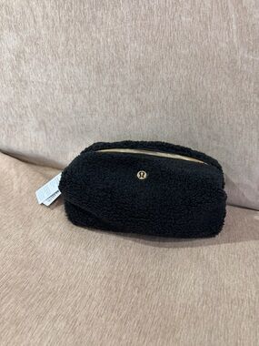 Lululemon limited edition black sherpa pouch with gold hardware